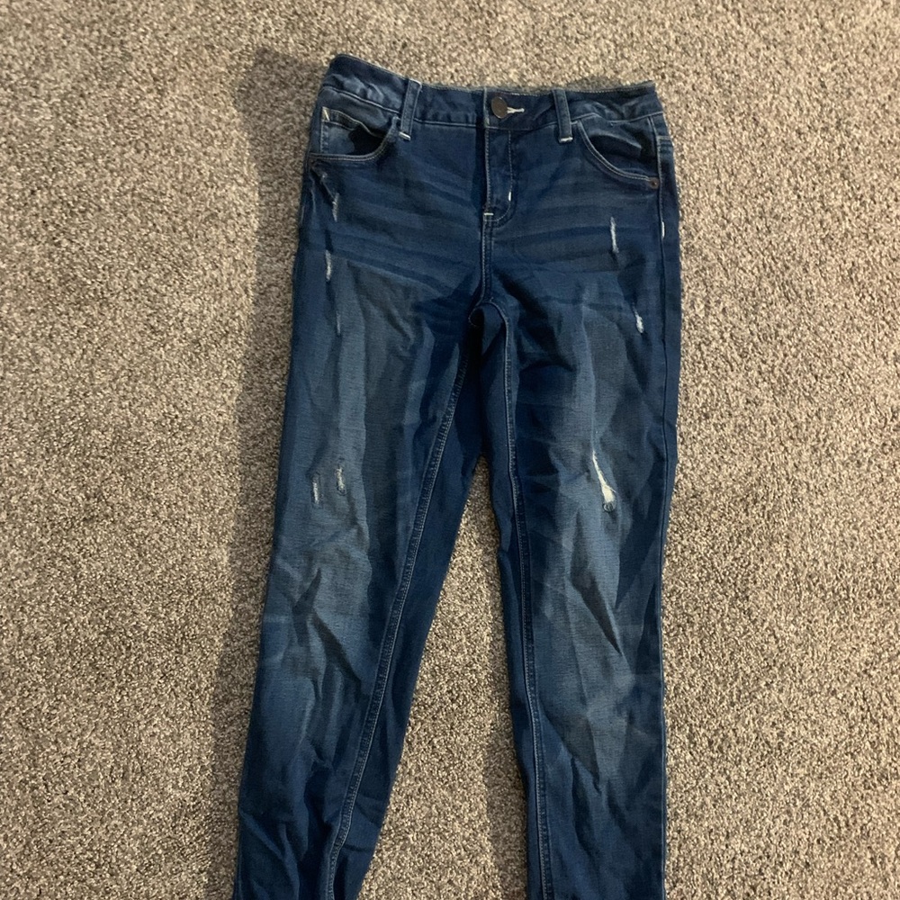 Slightly ripped dark washed jeans